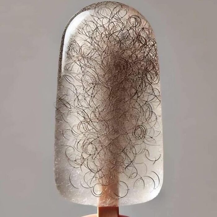 Transparent popsicle with embedded tangled hair strands, illustrating a disturbing cursed image from a daily cursed images Instagram page.