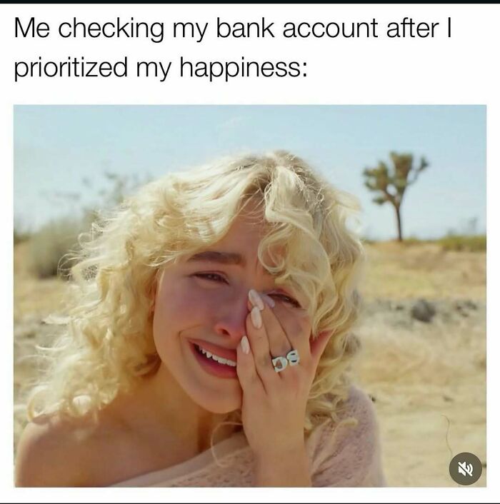 Young woman with curly blonde hair crying outdoors, representing introvert-worthy memes about prioritizing happiness and banking woes.
