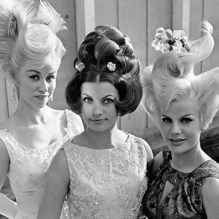 Three women with vintage hairstyles and dresses showcasing June Cleavers vintage closet fashion from an old-timey era.