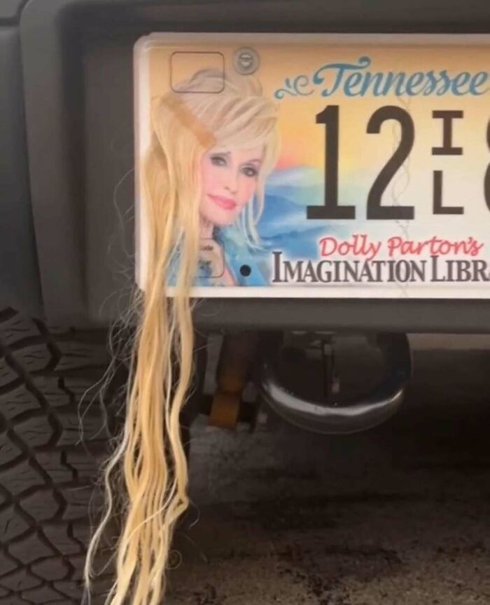 Tennessee license plate featuring Dolly Parton with long blonde hair attached, evoking a vintage closet era vibe.