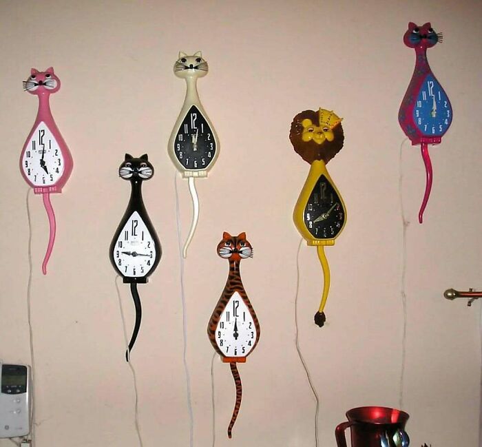 Vintage cats wall clocks with swinging tails in a retro style, evoking June Cleavers vintage closet nostalgia.