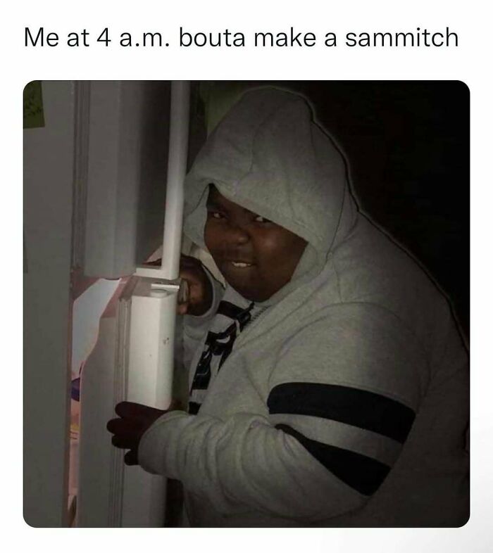 Person in a hoodie sneaking a late-night snack from the fridge, capturing a funny meme moment about relatable habits.