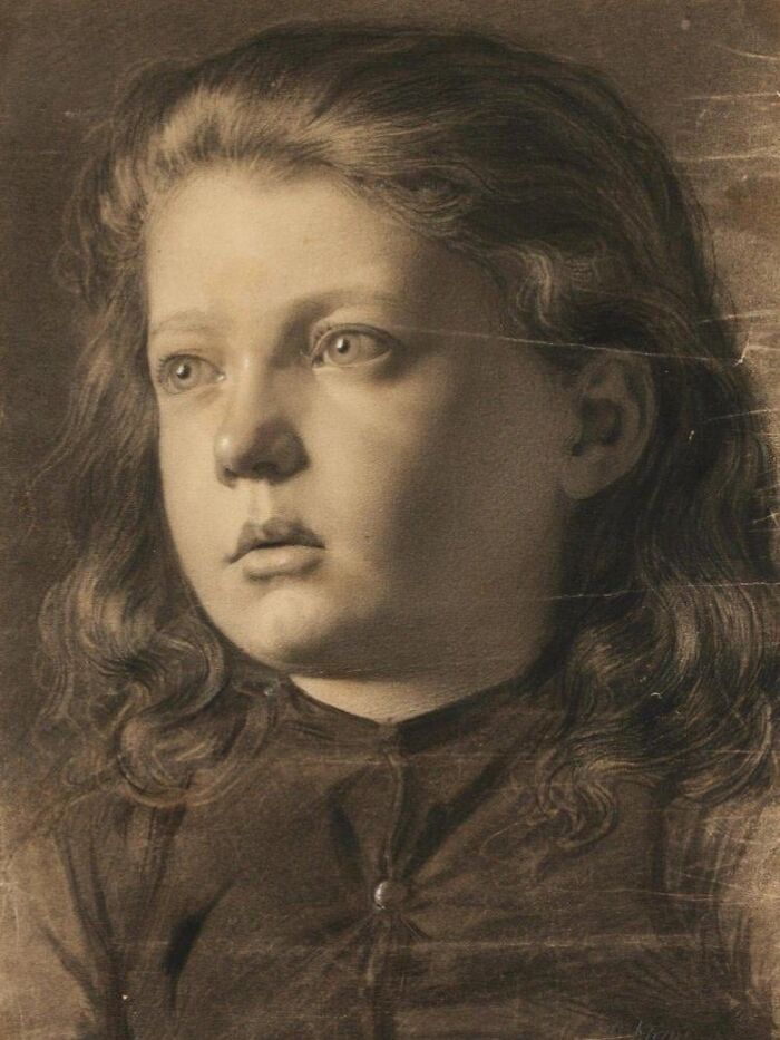 Sepia-toned historical photo of a young girl with wavy hair, capturing a poignant moment in history.