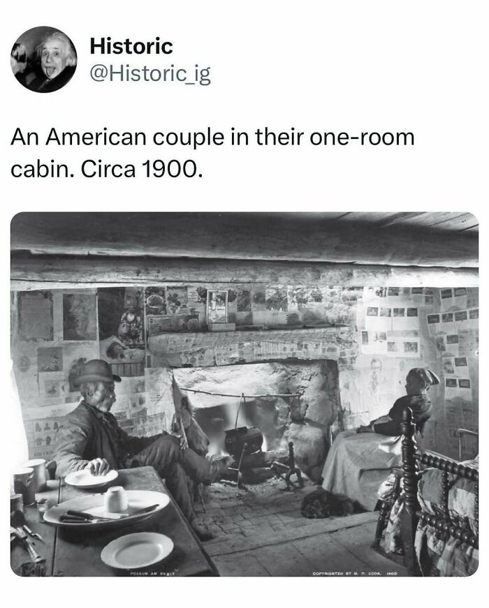Historic photo of an American couple in their one-room cabin circa 1900, showcasing daily life in early 20th century history.