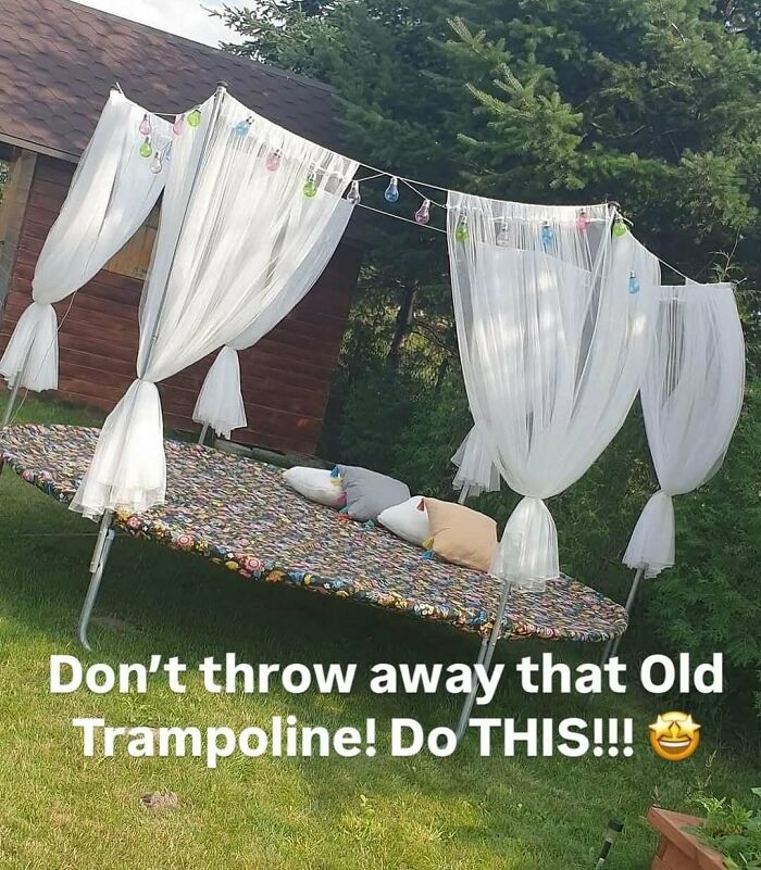 Outdoor lounge made from an old trampoline with sheer curtains and decorative pillows, showcasing crafty ideas from Instagram.