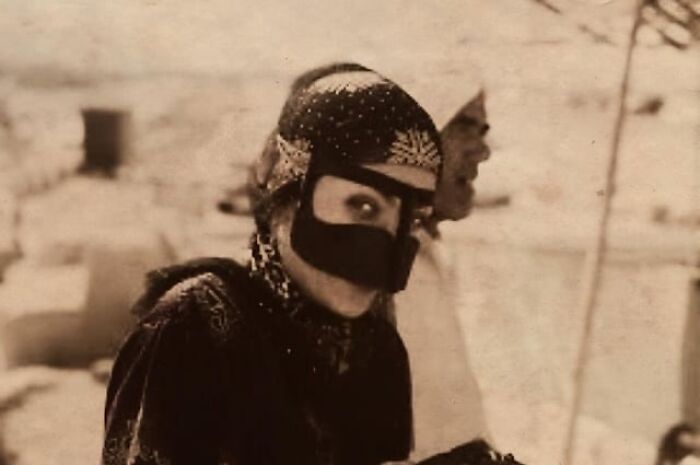 Woman wearing traditional face covering and headscarf in a historical photo with an interesting or heartbreaking backstory