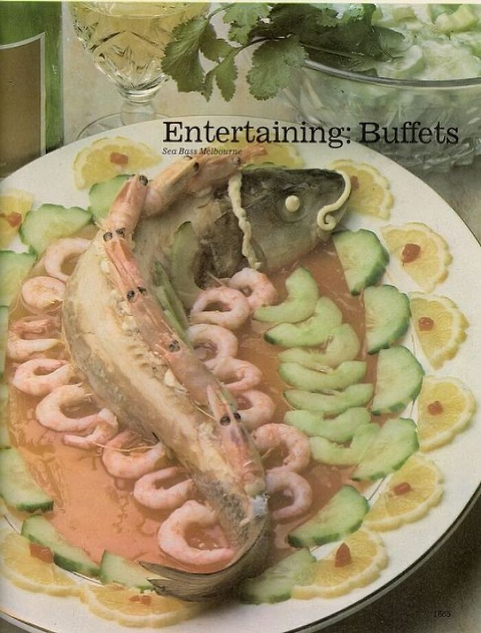 Vintage buffet plate with sea bass decorated with shrimp, cucumber, and lemon slices evoking June Cleavers vintage closet era.