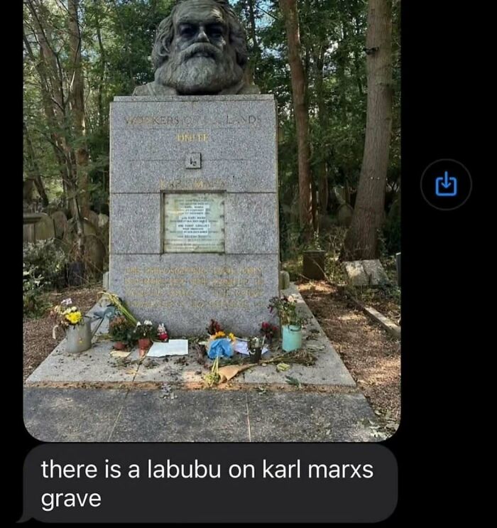 Statue of Karl Marx at his grave with flowers and plants, fitting memes for broken sense of humor content.