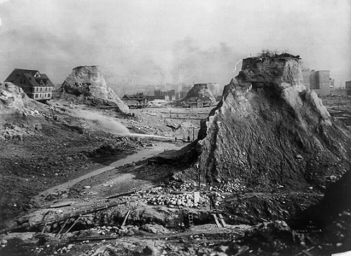 Historical photo showing large earth mounds in a barren urban area, illustrating an interesting or heartbreaking backstory.