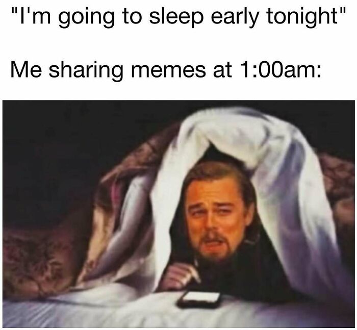 Man hiding under blanket at night, looking at phone and sharing hilarious memes for daily laughter and good vibes.