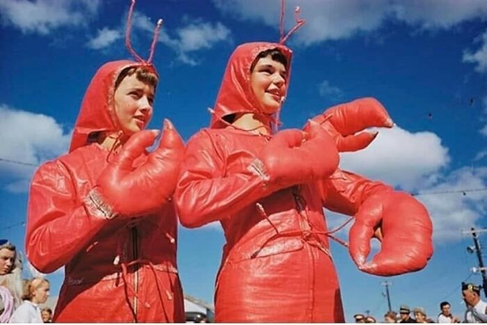 Two women in June Cleavers vintage closet lobster costumes posing outdoors under a blue sky.