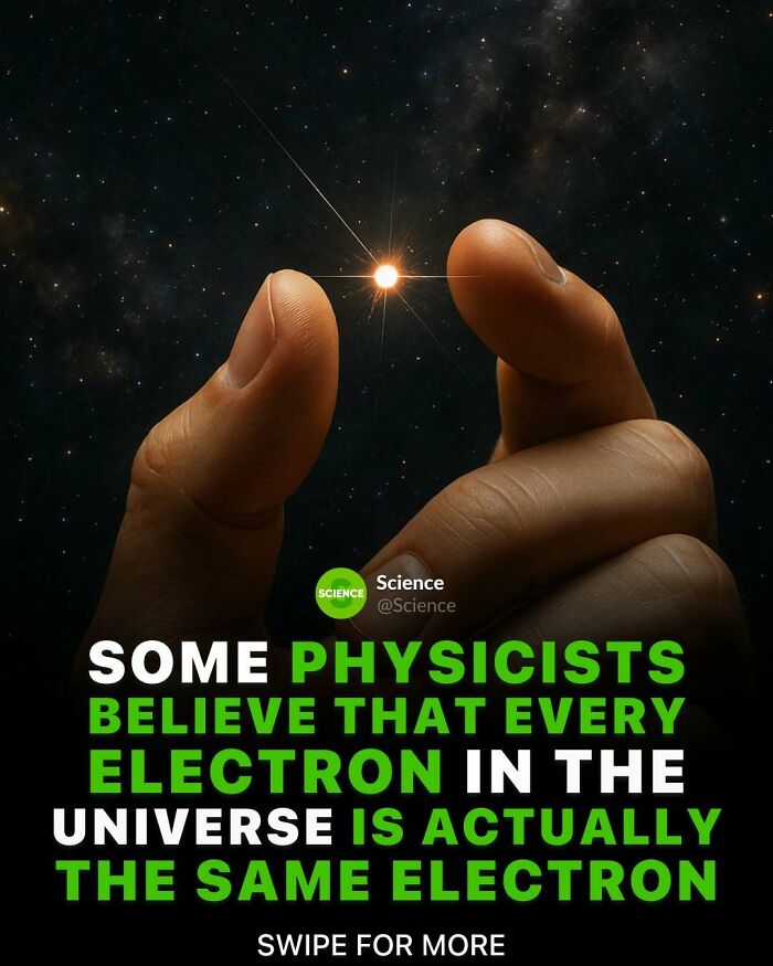 Hand holding a glowing electron against a starry universe background illustrating cool and interesting science facts.