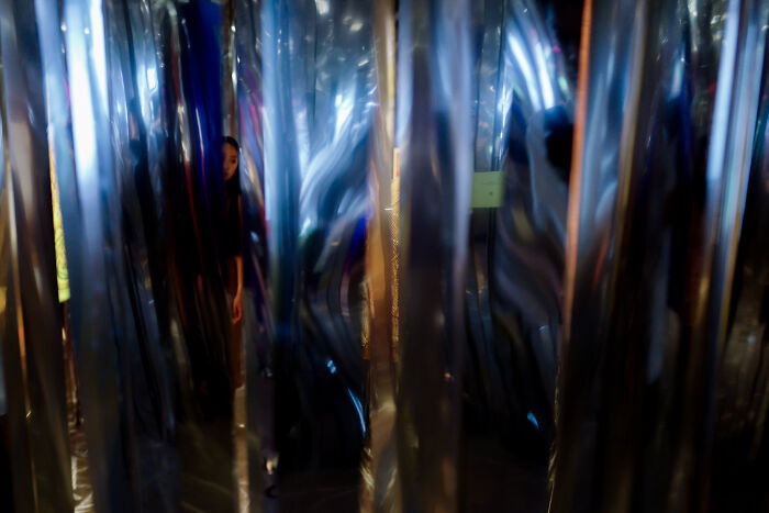 Photographer captures ordinary moments through poetic, cinematic images with dramatic lighting and reflective surfaces.