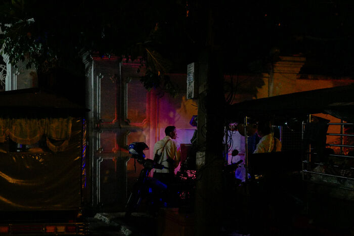 Photographer captures ordinary night moments in a poetic, cinematic style with vibrant colored lights and street scenes.