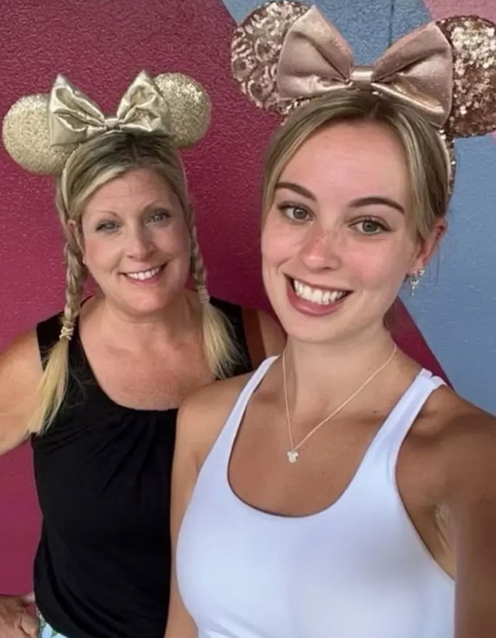 Two women wearing sparkly Minnie Mouse ears smiling at the camera, related to Disney World incident twist.