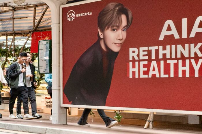 Street coincidences captured on camera showing a person’s legs aligning perfectly with a billboard image.