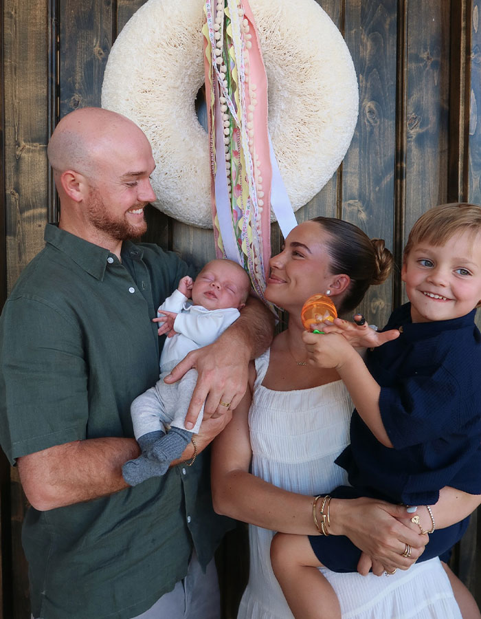 Family posing happily with two young children, highlighting momfluencer's full accountability after tragic drowning incident.