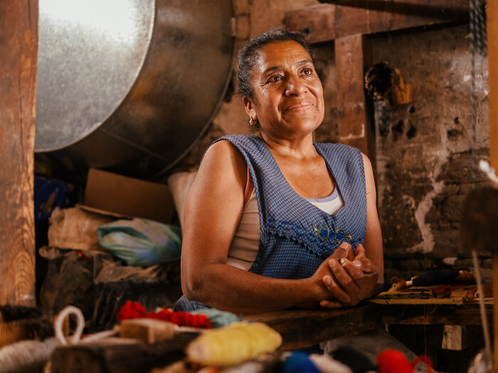 Woman in a rustic setting captured in authentic street photography showing everyday life moments and emotions.