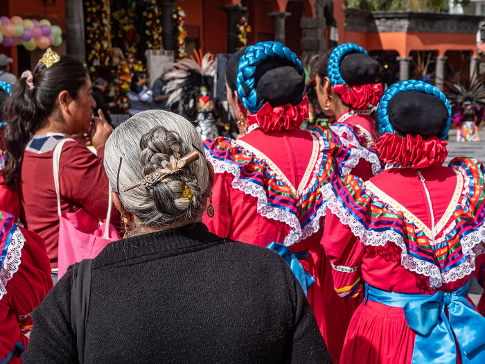 Women in traditional colorful dresses and braided hair, captured in street photography shots of daily life.