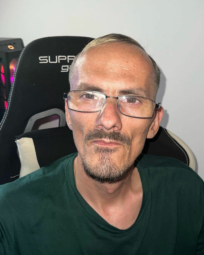Streamer with glasses and goatee sitting in a gaming chair, looking into the camera, related to famous streamer news. Streamer with glasses and goatee sitting in a gaming chair, looking into the camera, related to famous streamer news.