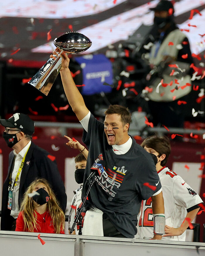 Tom Brady celebrating with Vince Lombardi Trophy amid confetti, related to Gisele B&uuml;ndchen furious over parenting jab.