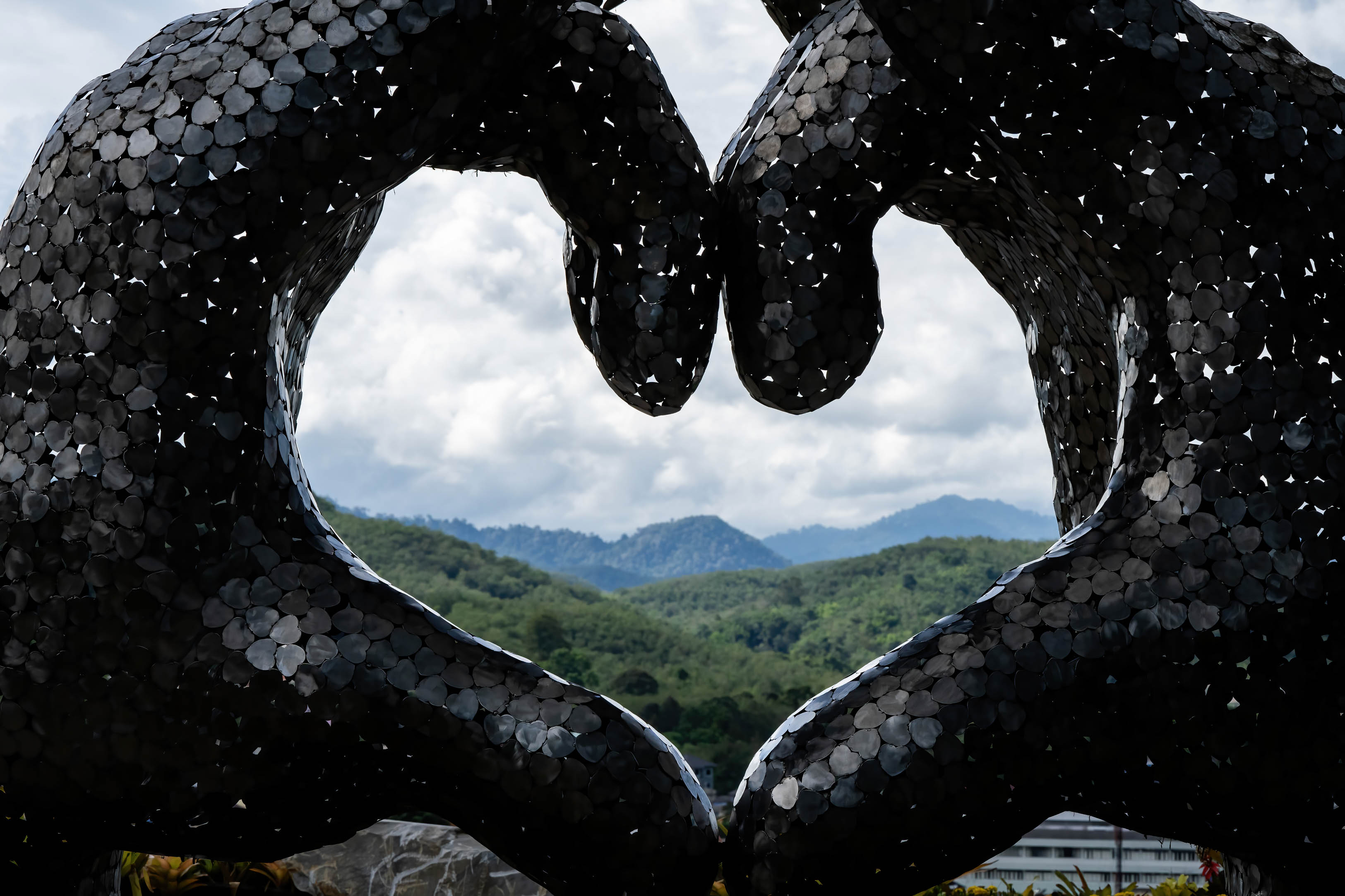 Artwork of a heart emoji frames mountains in the distance in Yala Province. Located on the Thai-Malaysian border. Artwork of a heart emoji frames mountains in the distance in Yala Province. Located on the Thai-Malaysian border.