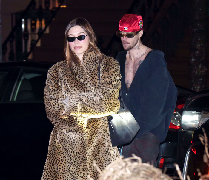 Hailey in a leopard coat and sunglasses with Justin Bieber in a red cap and dark jacket amid marriage struggles and album success. Hailey in a leopard coat and sunglasses with Justin Bieber in a red cap and dark jacket amid marriage struggles and album success.