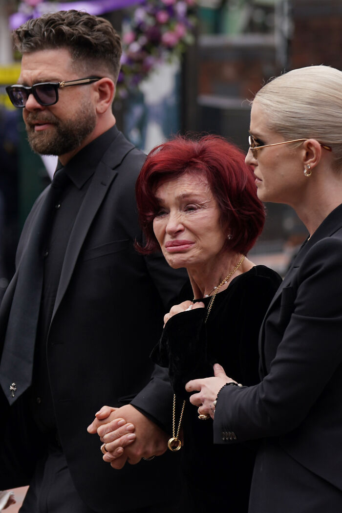 Mourners at emotional farewell, rock legends gathered for Ozzy Osbourne burial at family estate near lakeside.