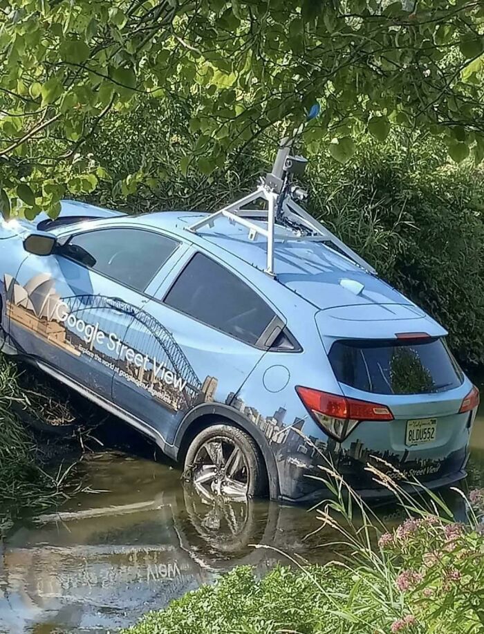 Google Street View car stuck in a ditch with water and mud, showing one of the funniest parking fails captured online.