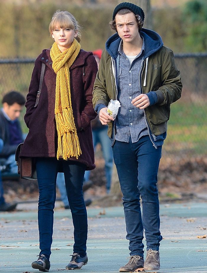 Young woman and man walking outdoors in casual fall clothing, body language expert discusses Travis Kelce traits.