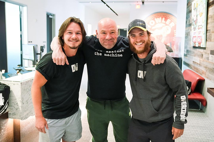Dana White smiling with two men in casual clothing, highlighting UFC and Dana White's net worth growth.