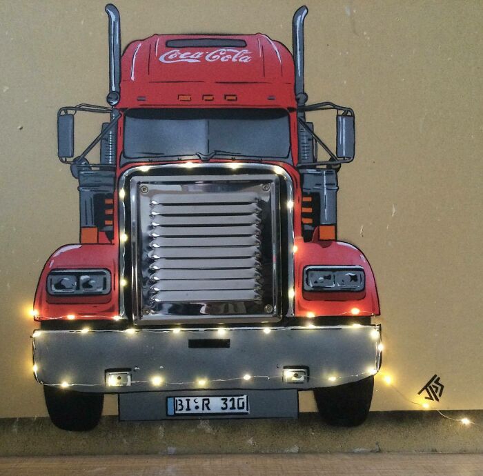 Graffiti art of a red truck with integrated lights creates an interactive and creative street mural on a plain wall.