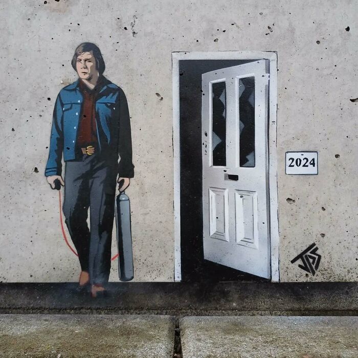 Graffiti art on a wall showing a man holding a gas canister next to an open door, interacting with the surroundings.