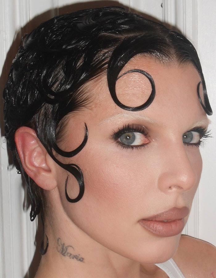 Julia Fox with artistic styled hair and makeup, highlighting her look amid plastic surgeries discussion.