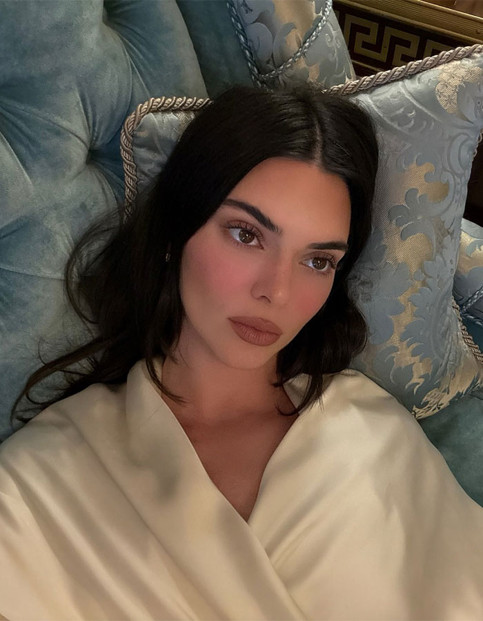 Kendall Jenner relaxing on a plush couch, sparking buzz related to Justin Bieber dive bar pic and Hailey&rsquo;s comment.