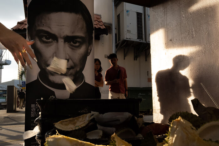 Street photographer captures ordinary life with shadows, portraits, and urban moments in a striking, artistic composition.