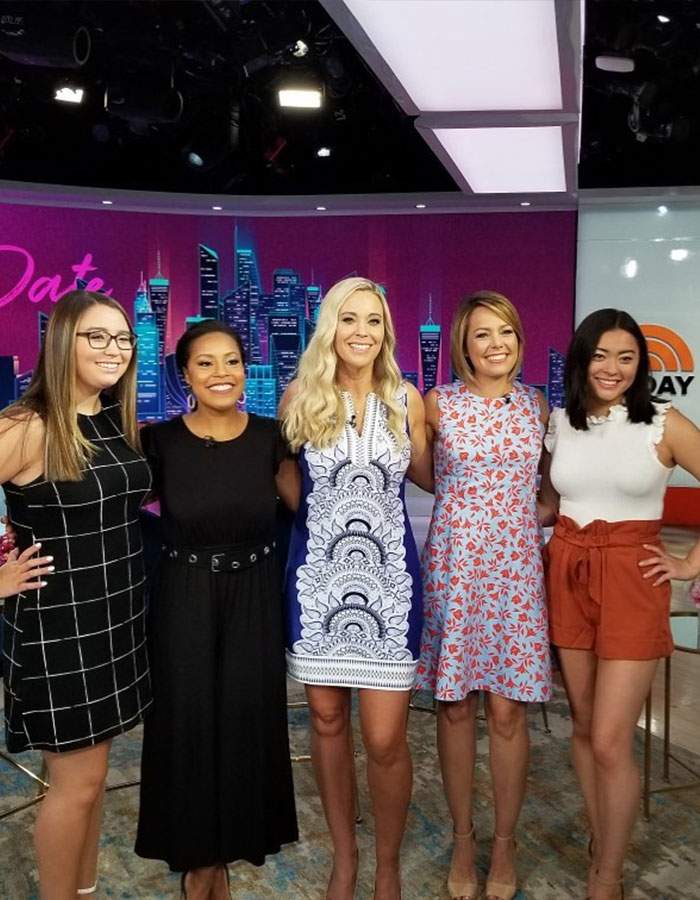 Five women smiling and posing on a TV show set, relating to reality star Kate Gosselin's return to nursing career after downfall.