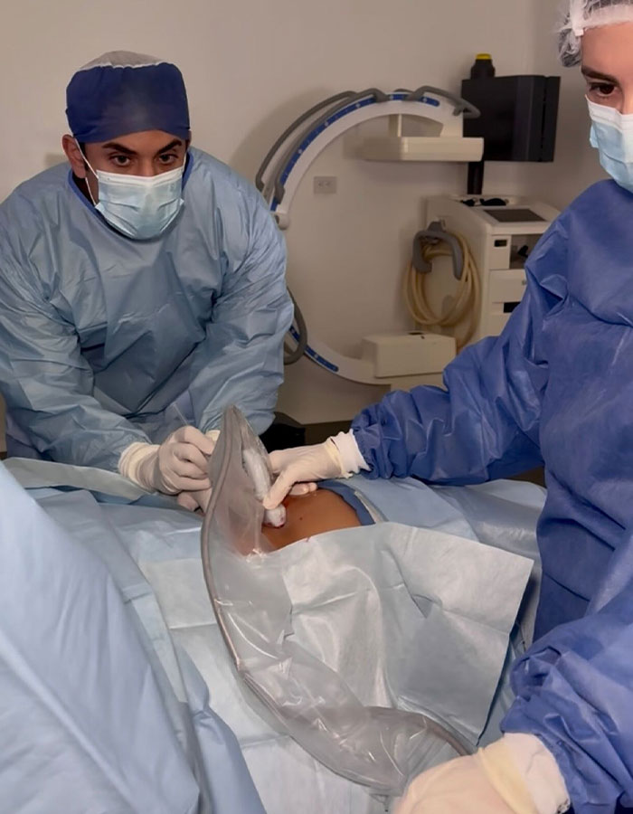 Medical professionals performing surgery in a sterile room during a procedure in Mexico unavailable in US. Medical professionals performing surgery in a sterile room during a procedure in Mexico unavailable in US.