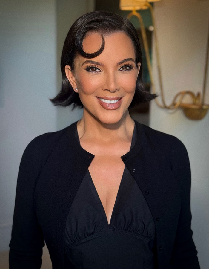Kris Jenner smiling indoors, wearing a black outfit, in a photo related to viral facelift and aging gracefully discussions. Kris Jenner smiling indoors, wearing a black outfit, in a photo related to viral facelift and aging gracefully discussions.