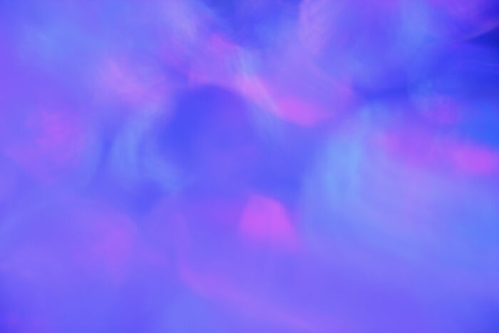 Abstract image with soft purple and pink hues creating a poetic, cinematic atmosphere in photography.