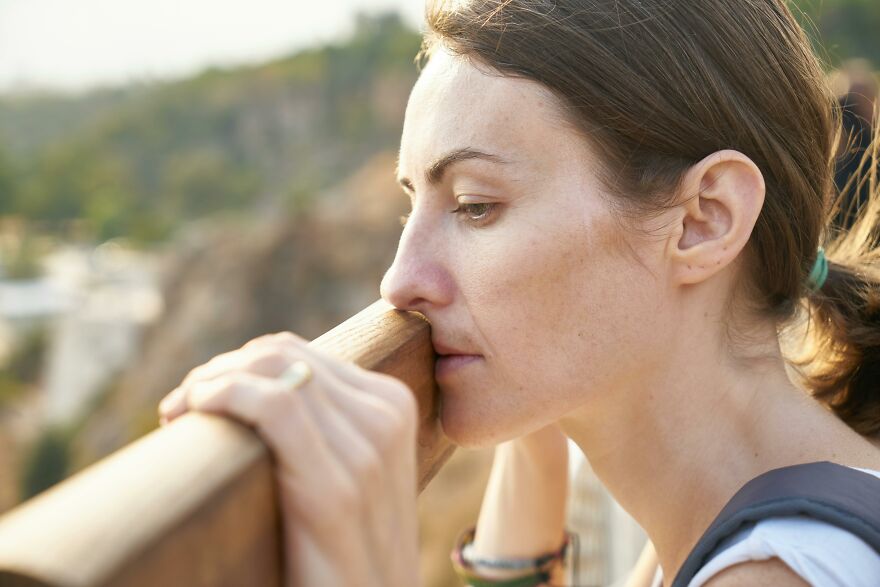 Woman looking thoughtful outdoors, reflecting on relationships and the closing gender gap in cheating behavior.