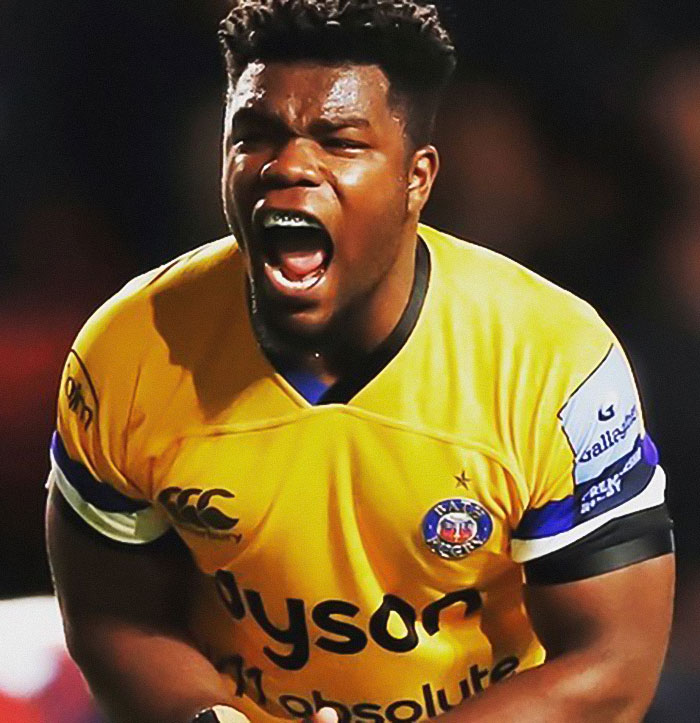 Rugby player in yellow jersey shouting passionately during a match, representing unsolved celebrity disappearances.