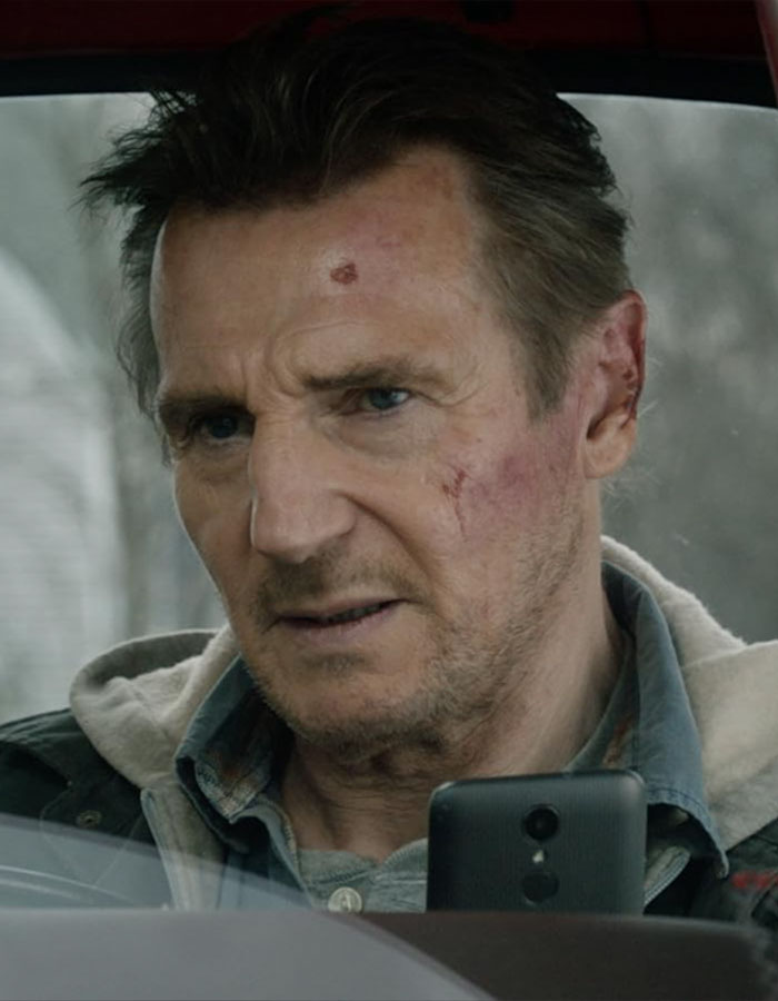 Liam Neeson with facial bruises inside a car, reflecting on recent rumored romance with Pamela Anderson. - 4