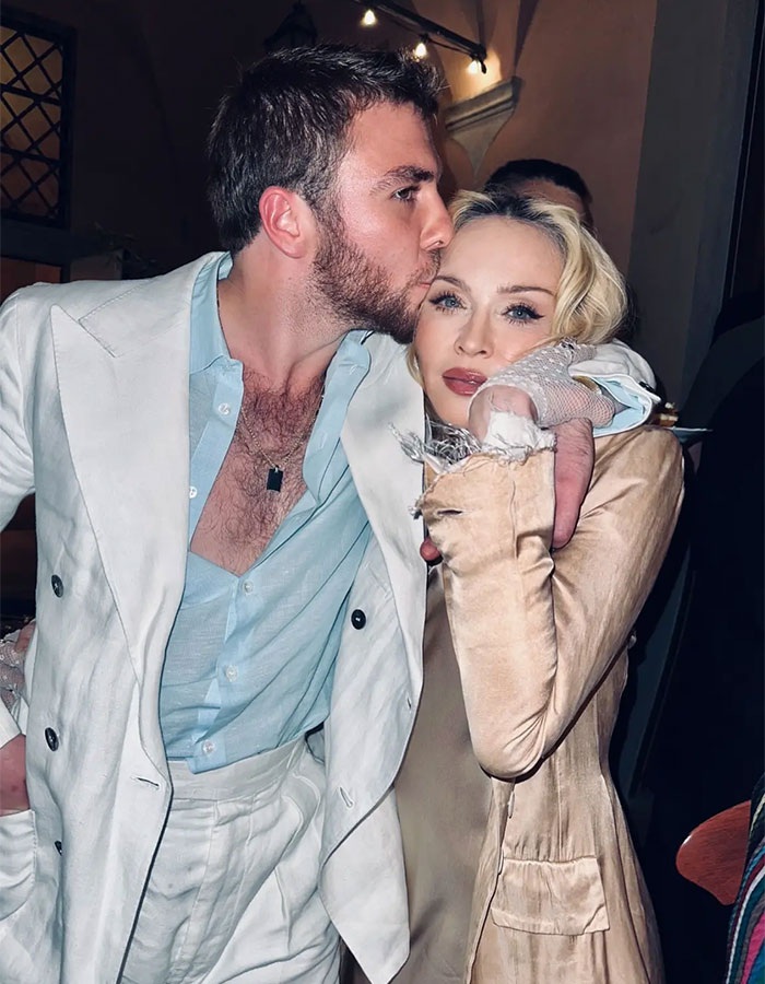 Madonna with her 29YO boyfriend sharing a tender moment amid talks of retirement age and cosmetic change advice.