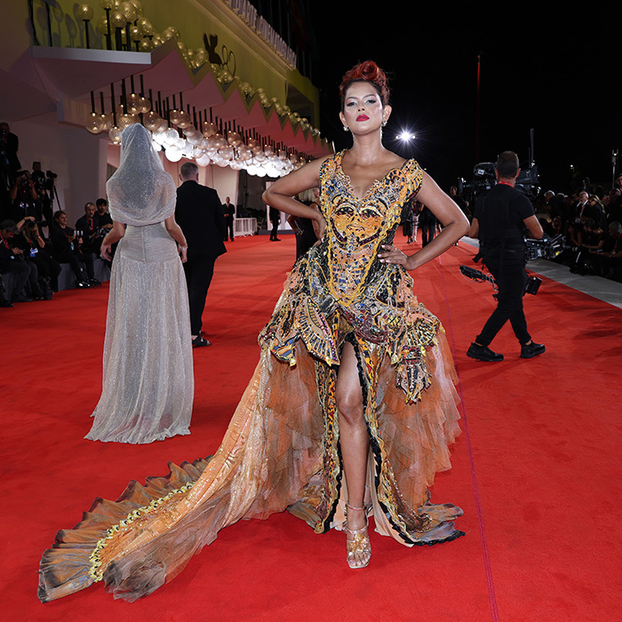 Star posing in a bold, intricate gown on the red carpet at Venice Film Festival 2025 worst dressed stars event.
