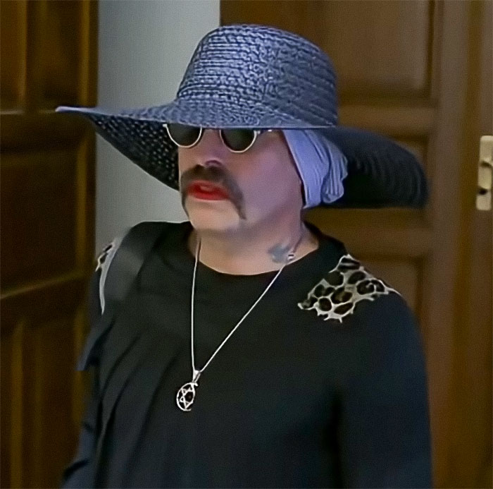 Radical right-winger with large hat and sunglasses after gender change, serving sentence in women's jail.