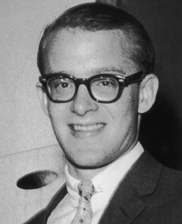 Black and white portrait of a man wearing glasses, relevant to celebrities and important figures with unsolved disappearances.