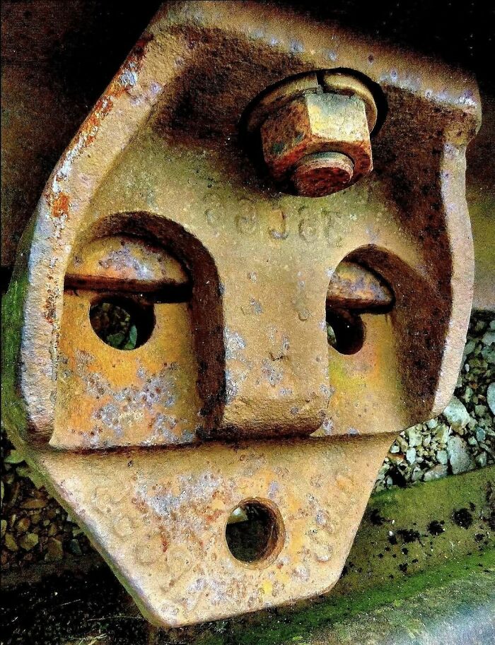 Rusty metal object resembling a face with eyes, nose, and mouth, posted in a group about random objects that look like faces.