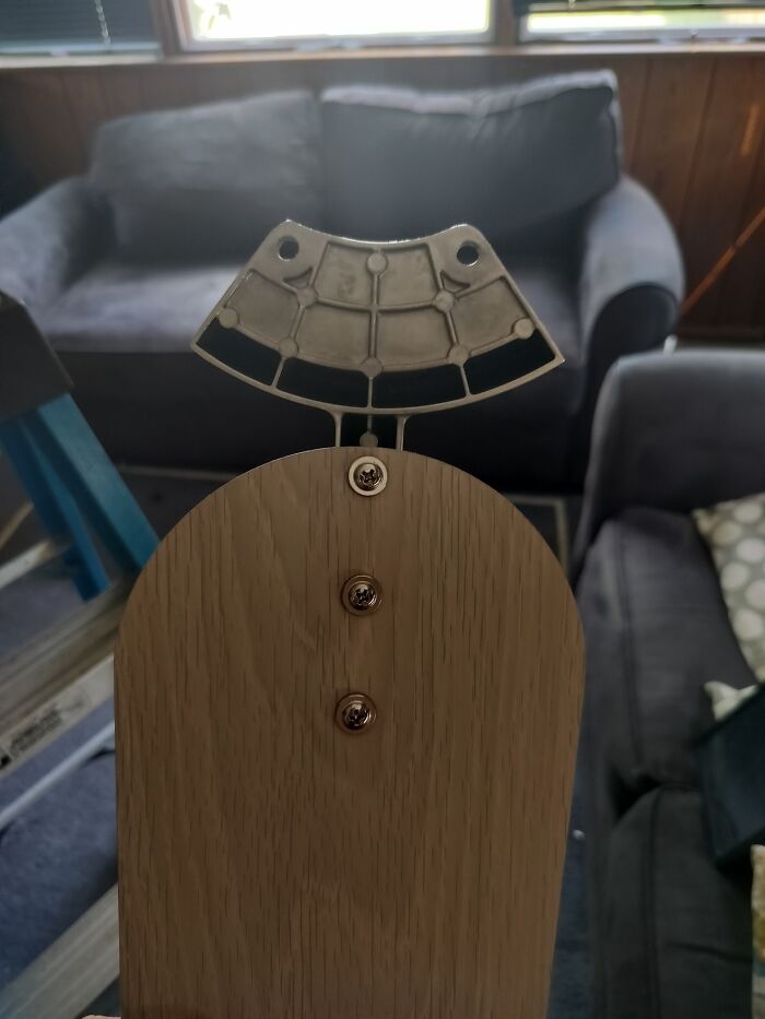 Random object resembling a face with buttons as eyes and nose shown in a living room, from a face-lookalike collection.