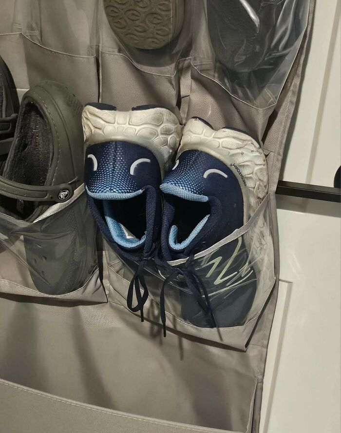 Shoes stored in a hanging organizer resembling happy faces, a random object that looks like a face in the Facebook group.